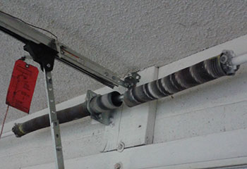 Damaged garage door torsion spring before replacement in Crystal Lake home