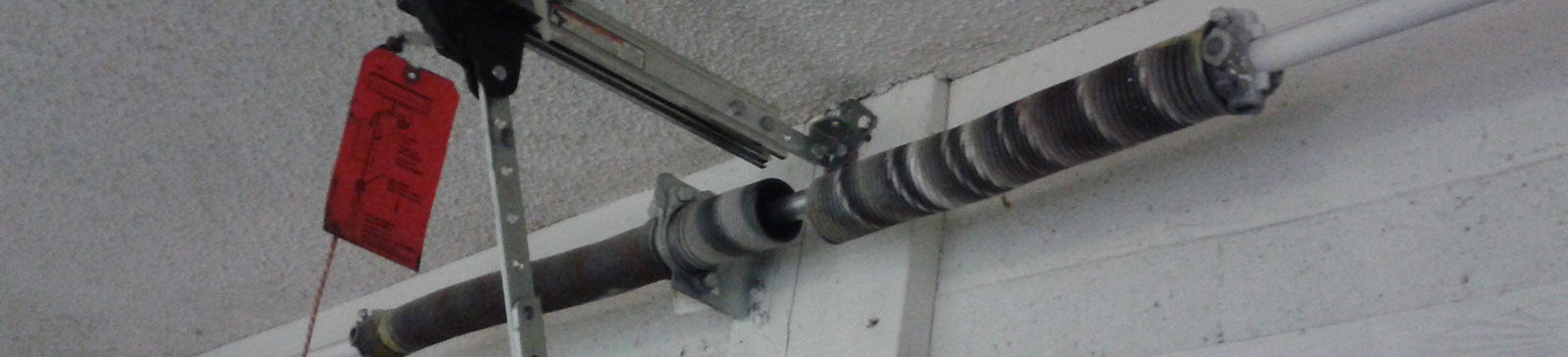 Damaged garage door torsion spring before replacement in Crystal Lake home