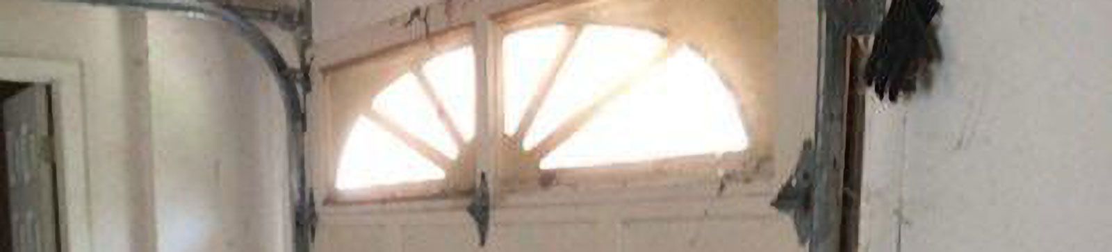 Lower panel heavily damaged on residential garage door before repair in Cary, IL